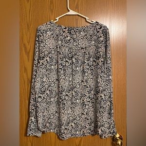 Long sleeve blouse with wide wrist cuff. Button detail at the shoulders